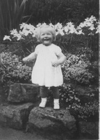 Ann b-1949 smiling in flowers